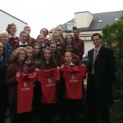 Ger Presenting Jersey’s to Hockey Team